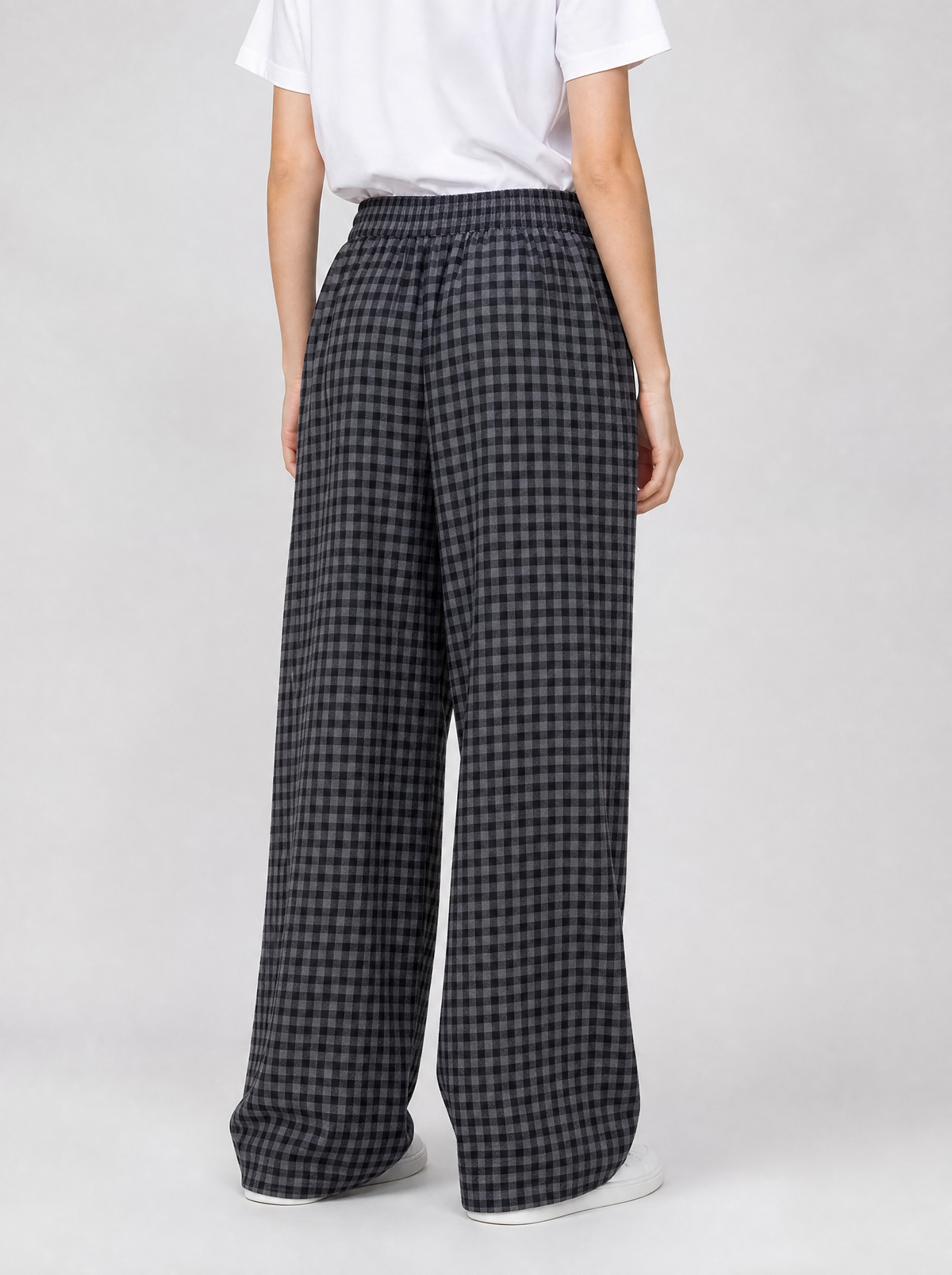 Back view of black check wide leg pants showing the elastic waistband and leg width