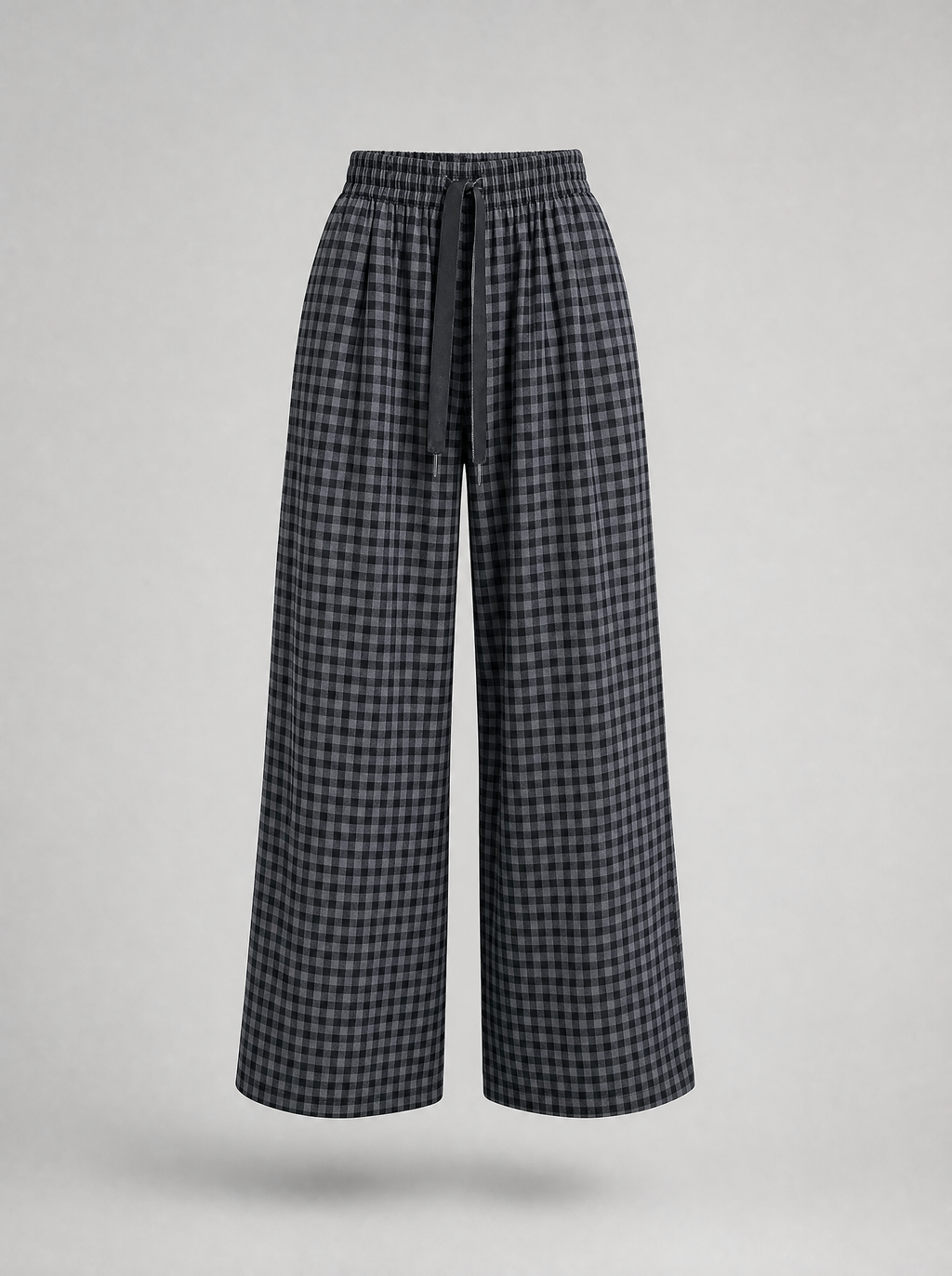 Black check wide leg pants shown on their own against a light grey background