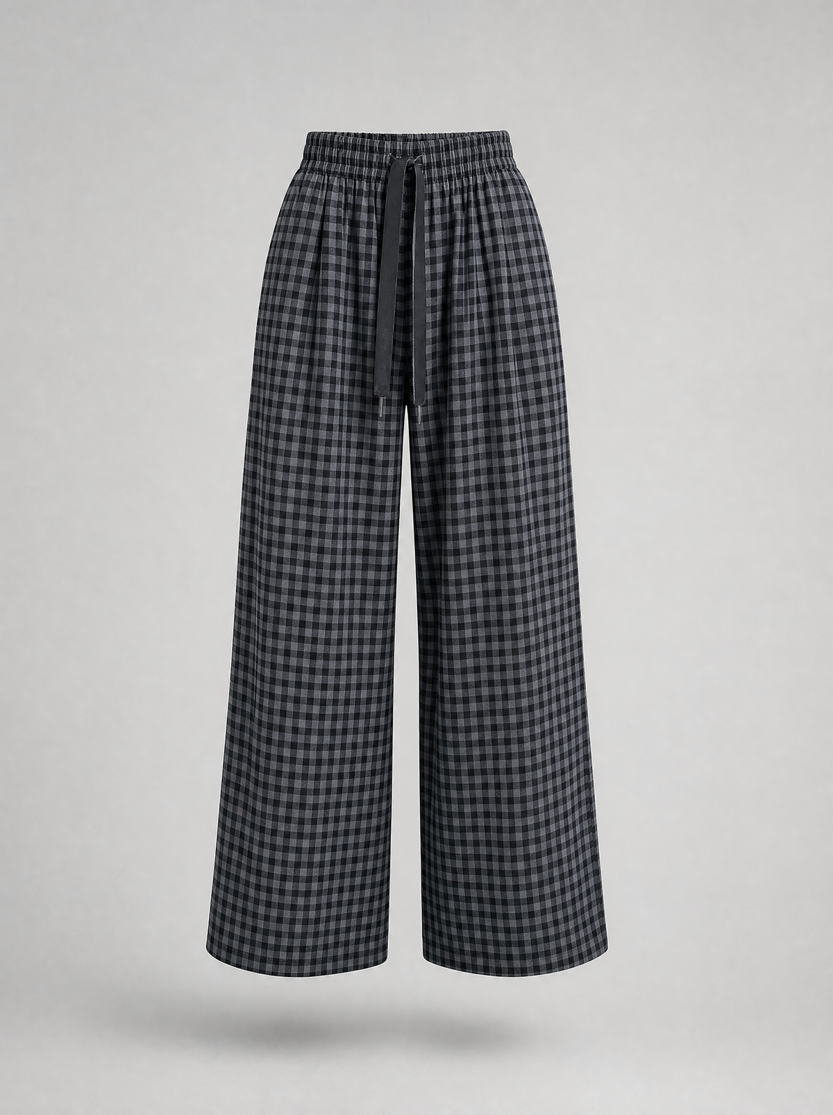 Black check wide leg pants shown on their own against a light grey background