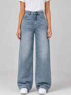 Woman wearing light wash high waist wide leg jeans, front view on a light grey studio background