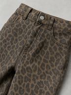 Close up of the waistband, shank button and leopard print denim on wide leg jeans