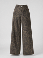 Leopard print wide leg jeans shown on their own against a light grey background