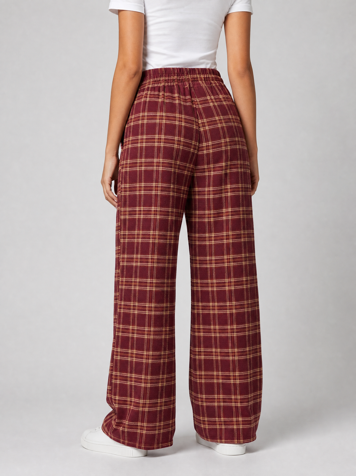 Back view of burgundy plaid wide leg pants showing the elastic waist and leg width