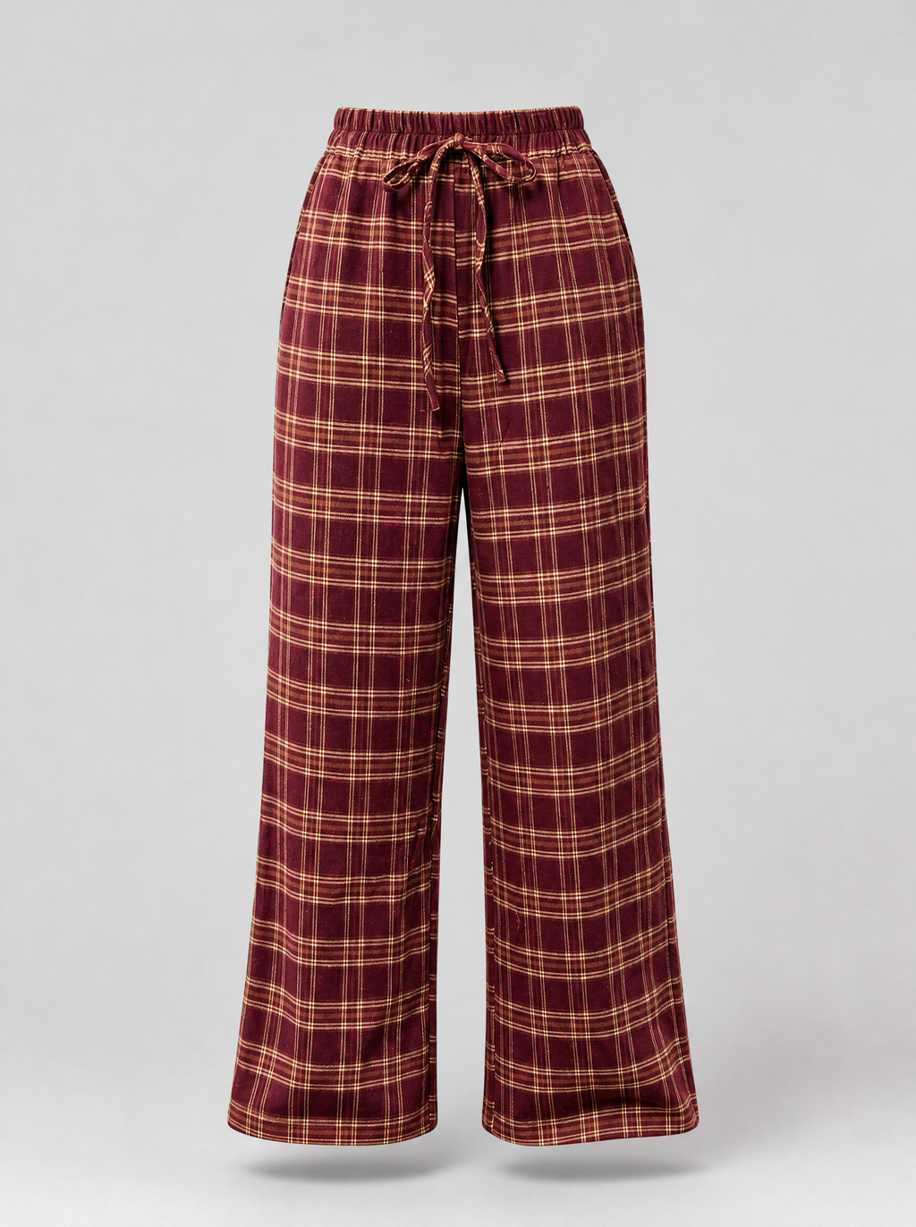 Burgundy plaid wide leg pants shown on their own against a light grey background