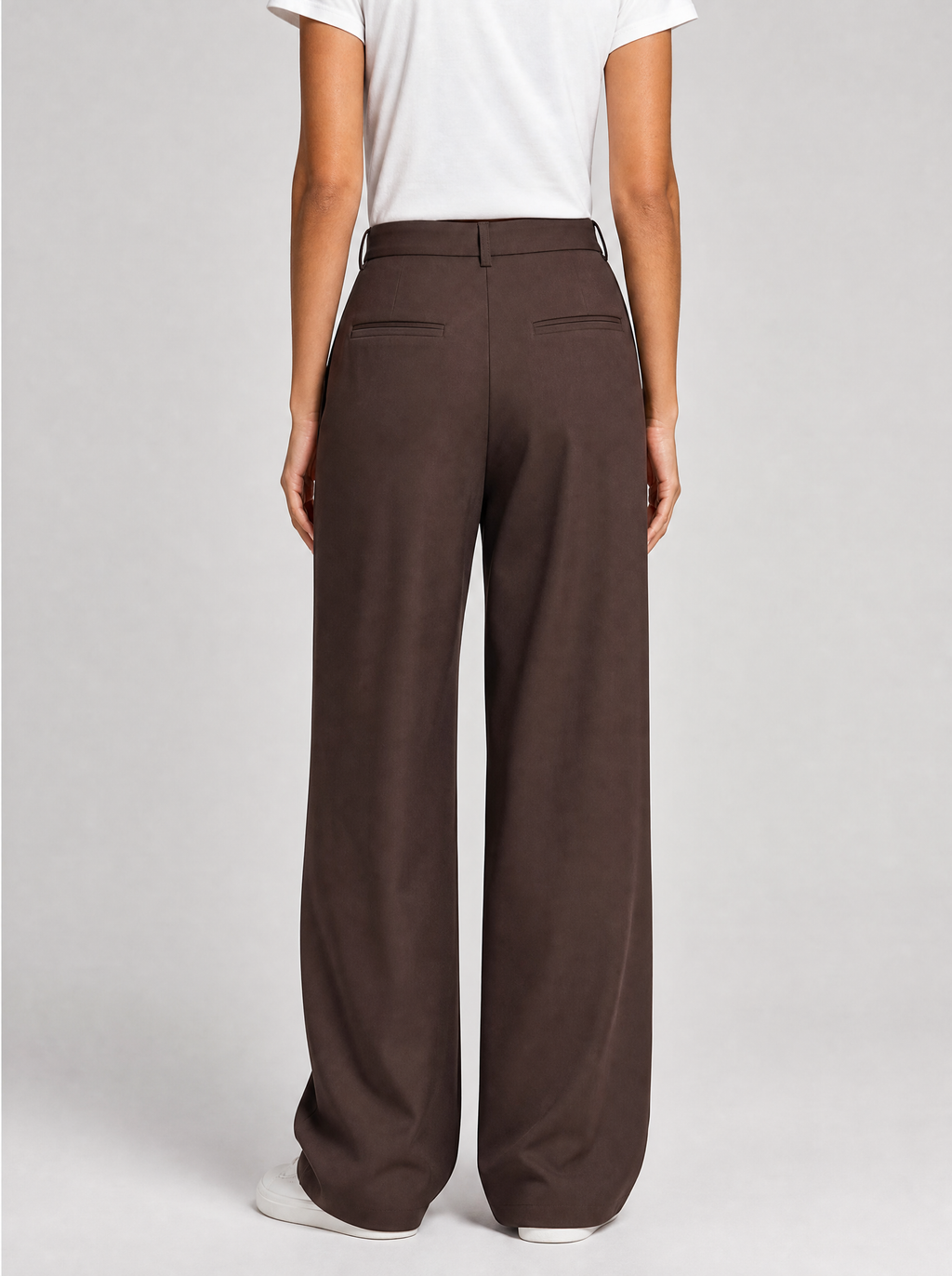 Back view of brown wide leg tailored trousers showing the waistband and back pockets