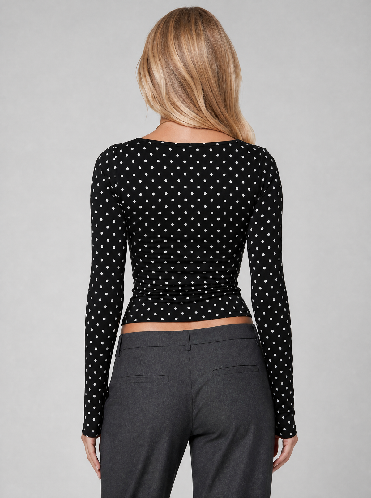 Back view of a black polka dot square neck long sleeve top showing the shoulder line