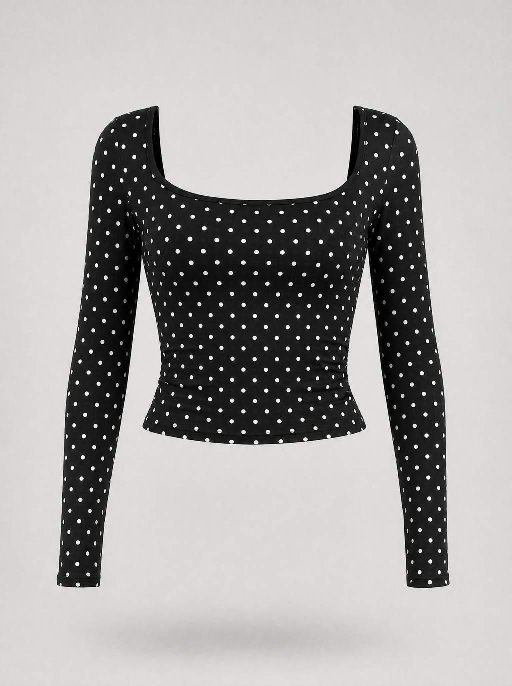 Black polka dot square neck long sleeve top shown on its own against a light grey background