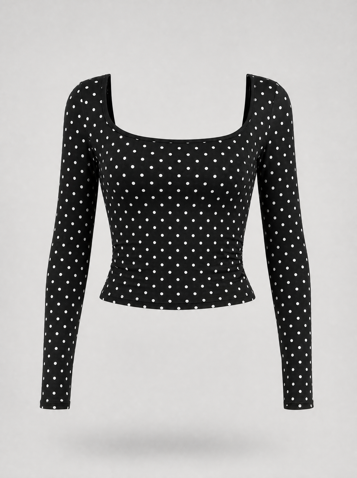 Black polka dot square neck long sleeve top shown on its own against a light grey background