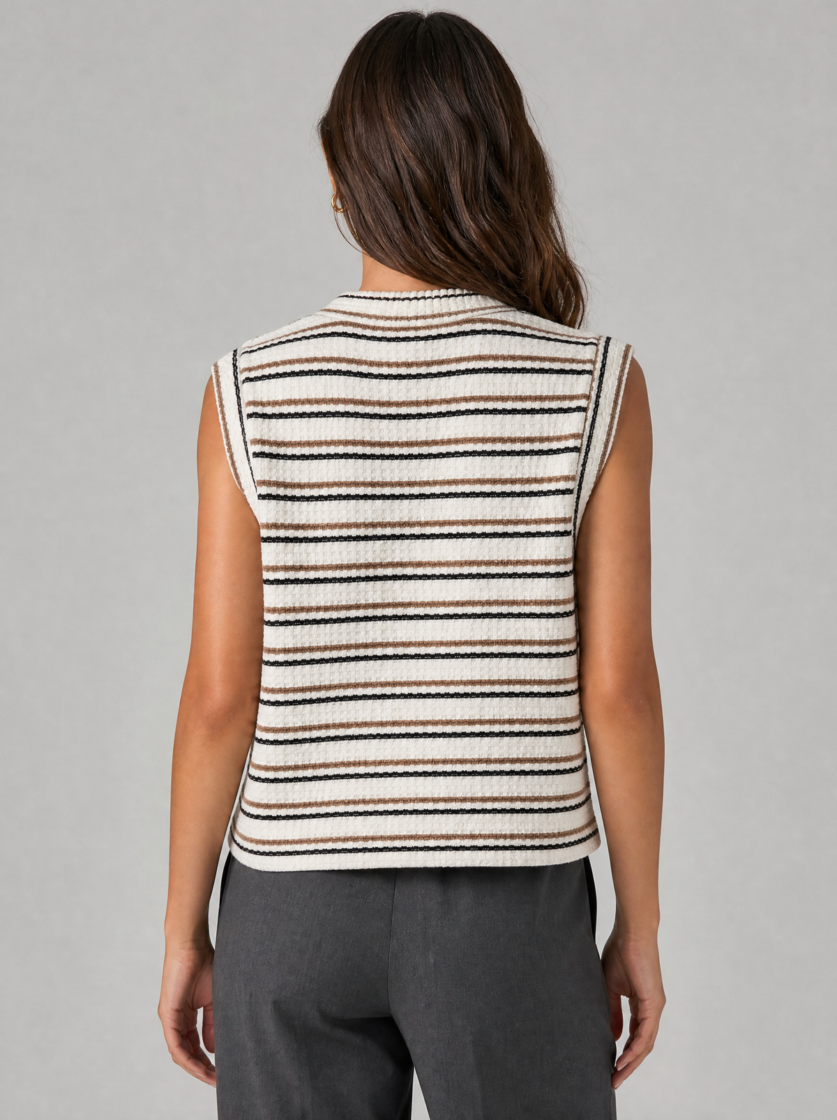 Back view of a cream striped sleeveless knit vest showing the shoulder line and armholes