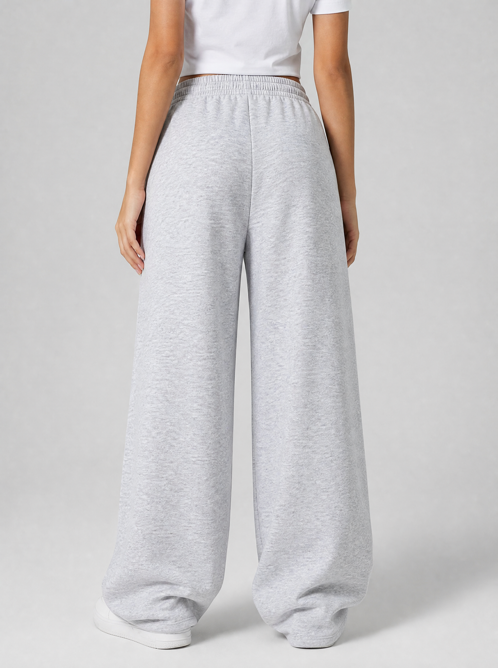 Back view of grey wide leg fleece sweatpants showing the elastic waist and leg width