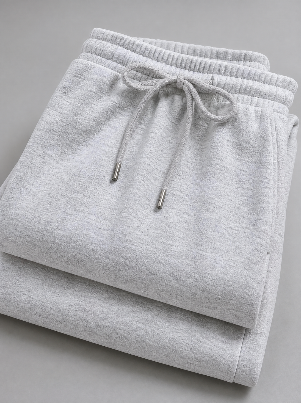 Close up of the drawstring waistband and brushed fleece on grey sweatpants